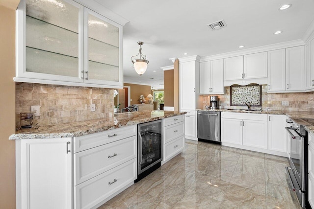 kitchen featuring tasteful backsplash, stainless steel appliances, pendant lighting, white cabinetry, and wine cooler