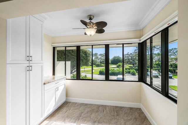 unfurnished sunroom featuring ceiling fan