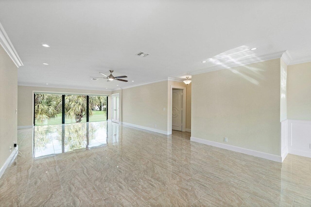 empty room featuring ceiling fan and crown molding