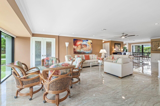 living room with ceiling fan, crown molding, a wealth of natural light, and french doors