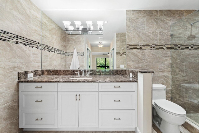 bathroom with toilet, a shower, tile walls, and vanity