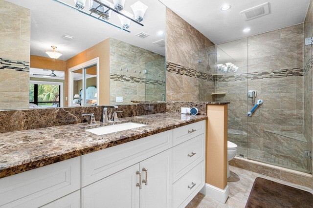 bathroom featuring an enclosed shower, vanity, toilet, and ceiling fan