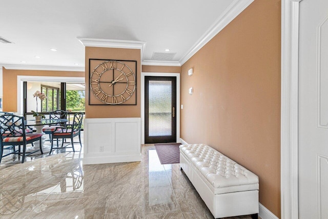 foyer featuring crown molding