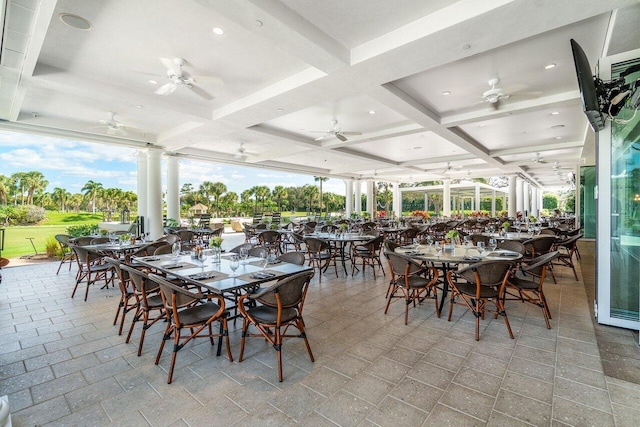 dining space featuring beamed ceiling, decorative columns, and coffered ceiling