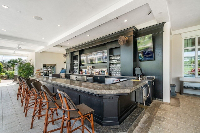 bar with beamed ceiling and ceiling fan