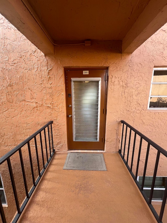 entrance to property with a balcony