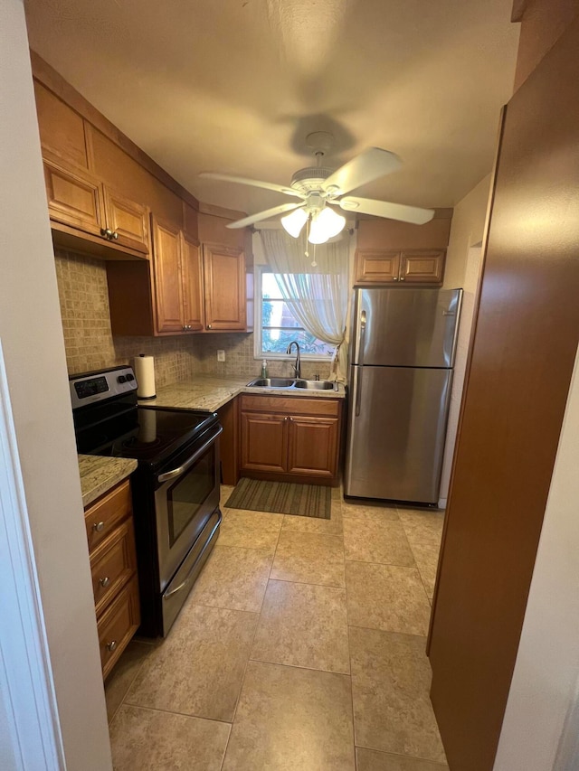 kitchen featuring stainless steel appliances, backsplash, ceiling fan, sink, and light tile floors