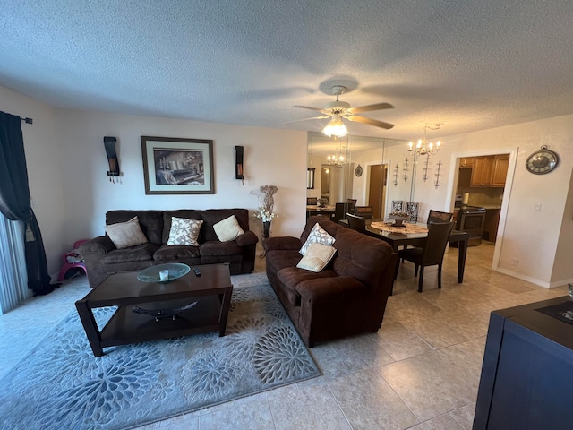 tiled living room with ceiling fan with notable chandelier and a textured ceiling