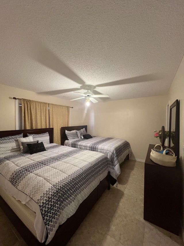 bedroom featuring a textured ceiling, tile flooring, and ceiling fan