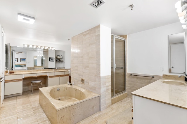 bathroom featuring ceiling fan, vanity, tile walls, tile patterned flooring, and independent shower and bath