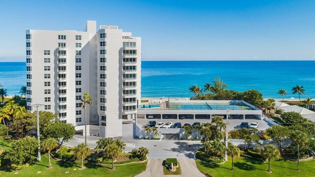 exterior space with a water view and a beach view