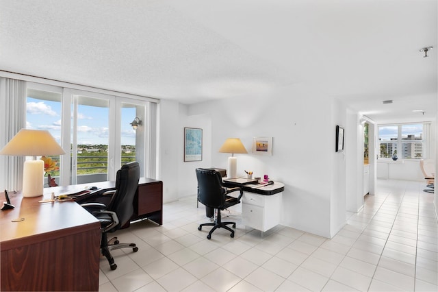 tiled home office with a textured ceiling