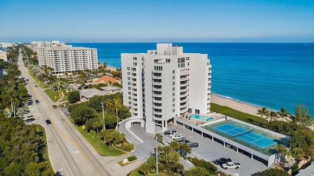 birds eye view of property featuring a view of the beach and a water view