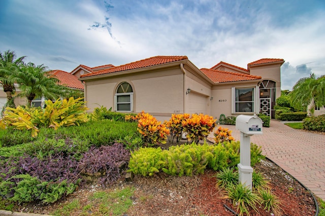 mediterranean / spanish home featuring a garage