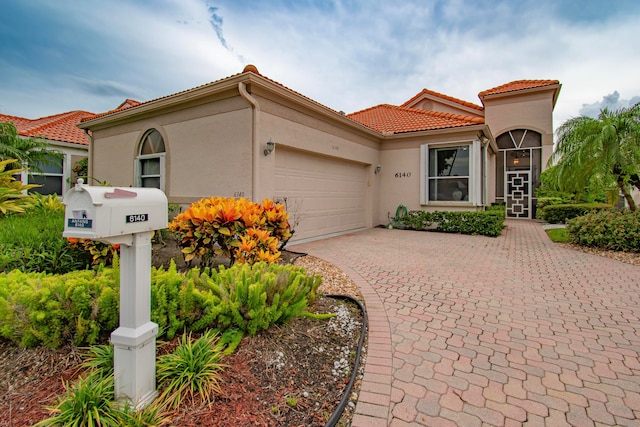 mediterranean / spanish-style home featuring a garage