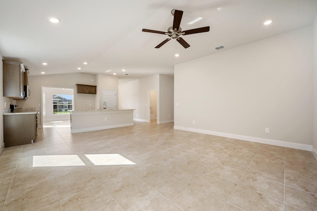 unfurnished living room featuring ceiling fan, light tile patterned floors, and lofted ceiling