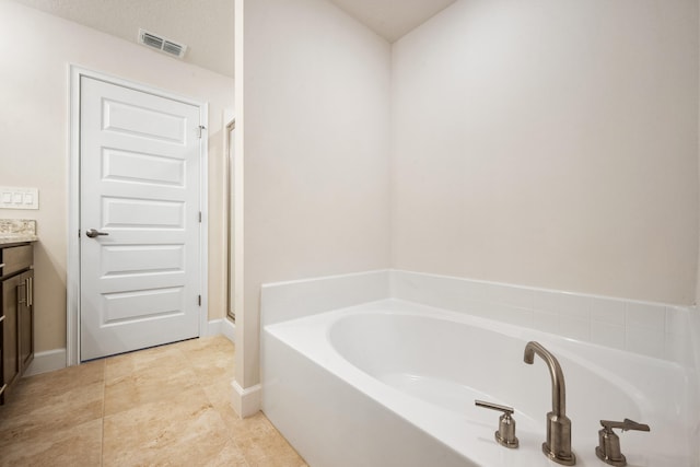 bathroom with vanity and a bath