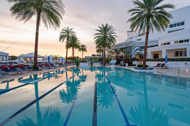 view of pool at dusk