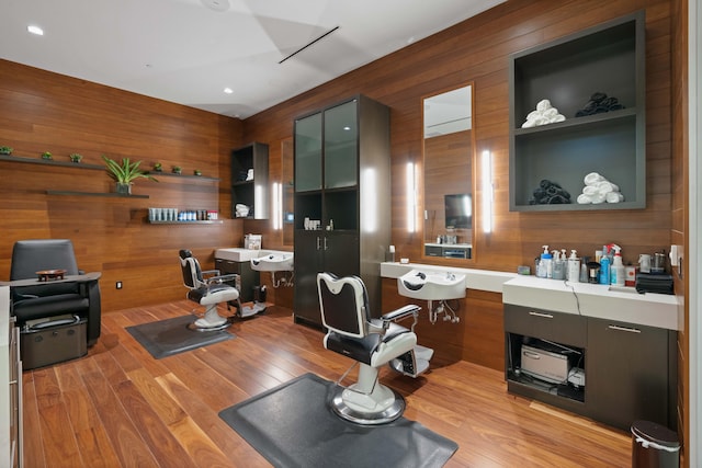 office area with wood walls and light hardwood / wood-style floors