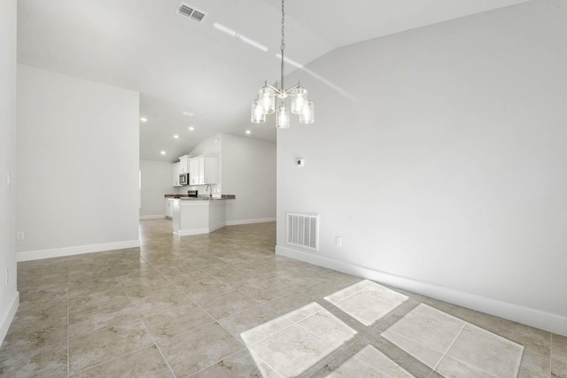 interior space featuring light tile patterned floors and vaulted ceiling