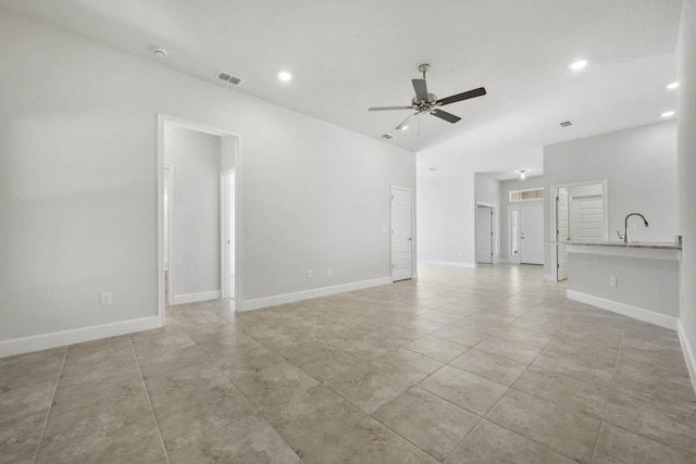 unfurnished room with ceiling fan and sink