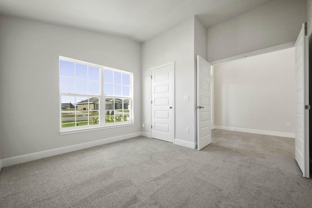 unfurnished bedroom featuring light carpet