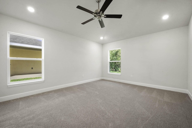 spare room featuring carpet flooring and ceiling fan