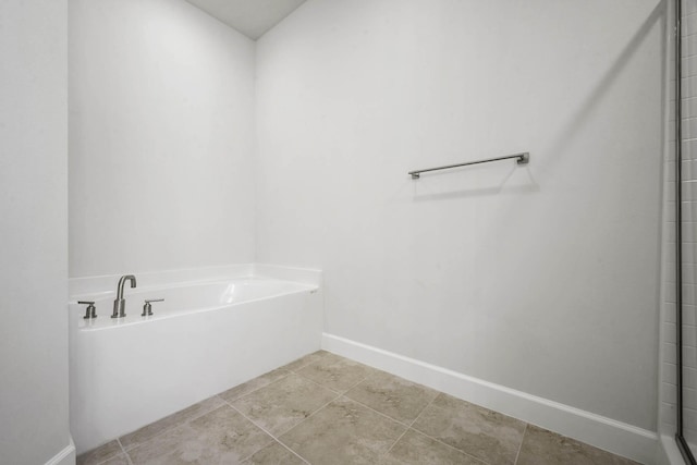 bathroom featuring a washtub and tile patterned flooring