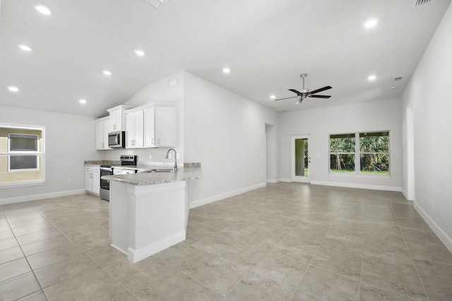 kitchen featuring light stone countertops, sink, kitchen peninsula, white cabinets, and appliances with stainless steel finishes