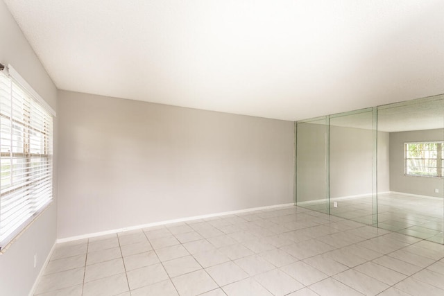 unfurnished room with light tile patterned floors