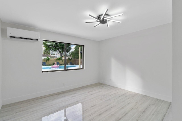 empty room with light hardwood / wood-style floors, an AC wall unit, and ceiling fan