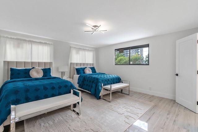 bedroom with ceiling fan and light wood-type flooring