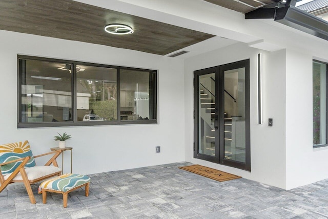 view of exterior entry featuring french doors