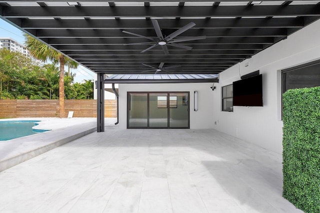 view of patio featuring a fenced in pool and ceiling fan