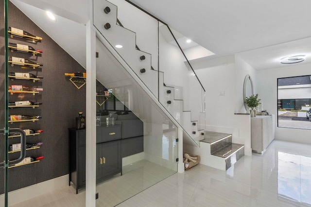 staircase featuring tile patterned flooring