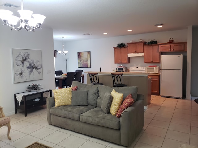 living room with light tile patterned flooring and a notable chandelier