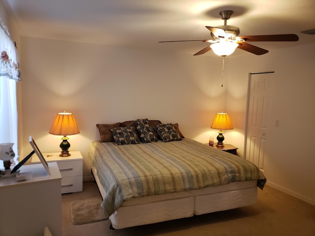 bedroom with ceiling fan, a closet, and carpet floors