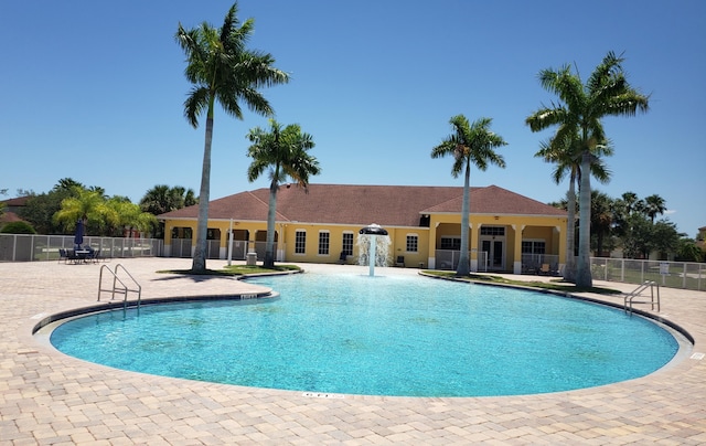 view of pool with pool water feature and a patio area