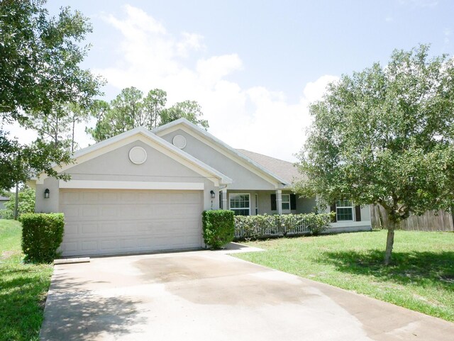 ranch-style house with a garage and a front yard