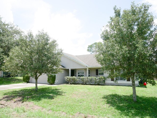 ranch-style home with a garage and a front lawn