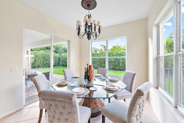 dining area with light tile patterned floors and a chandelier