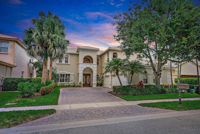 mediterranean / spanish-style house with a lawn