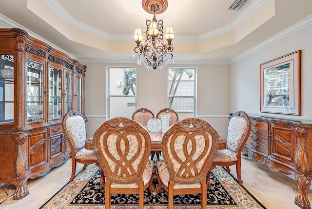 dining area featuring light tile patterned floors, a tray ceiling, ornamental molding, and a notable chandelier