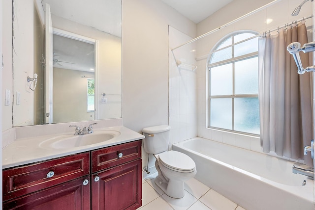 full bathroom featuring tile patterned flooring, vanity, toilet, and a wealth of natural light