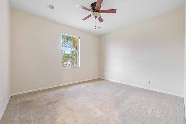 spare room with light carpet and ceiling fan