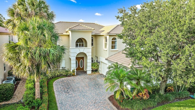 mediterranean / spanish-style house with a garage