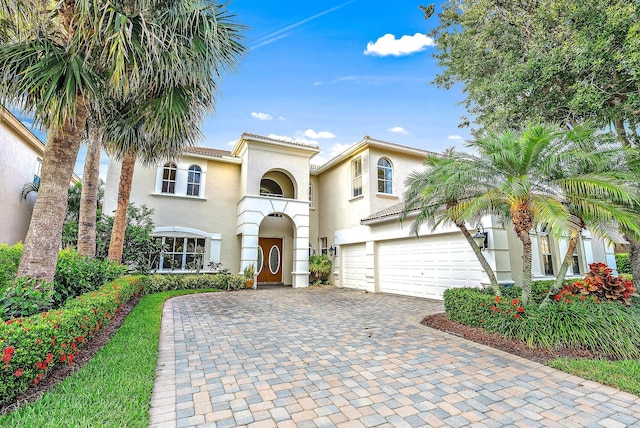 mediterranean / spanish home featuring a garage