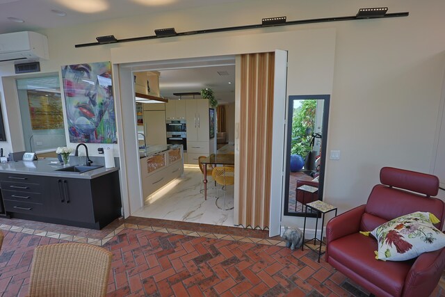 dining area featuring sink, a skylight, an AC wall unit, expansive windows, and ceiling fan