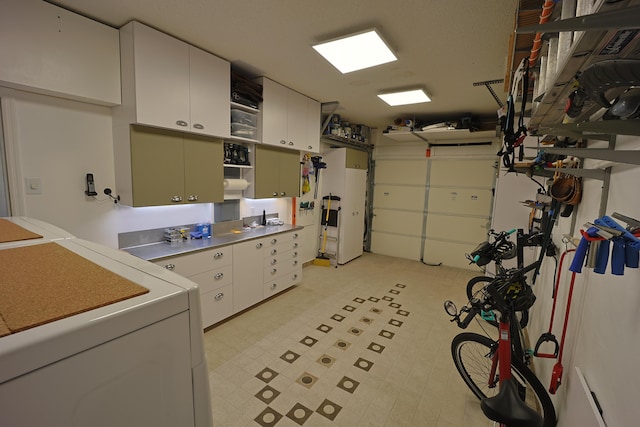 laundry area with cabinets and washing machine and dryer