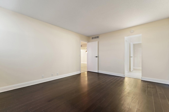 spare room featuring dark hardwood / wood-style flooring